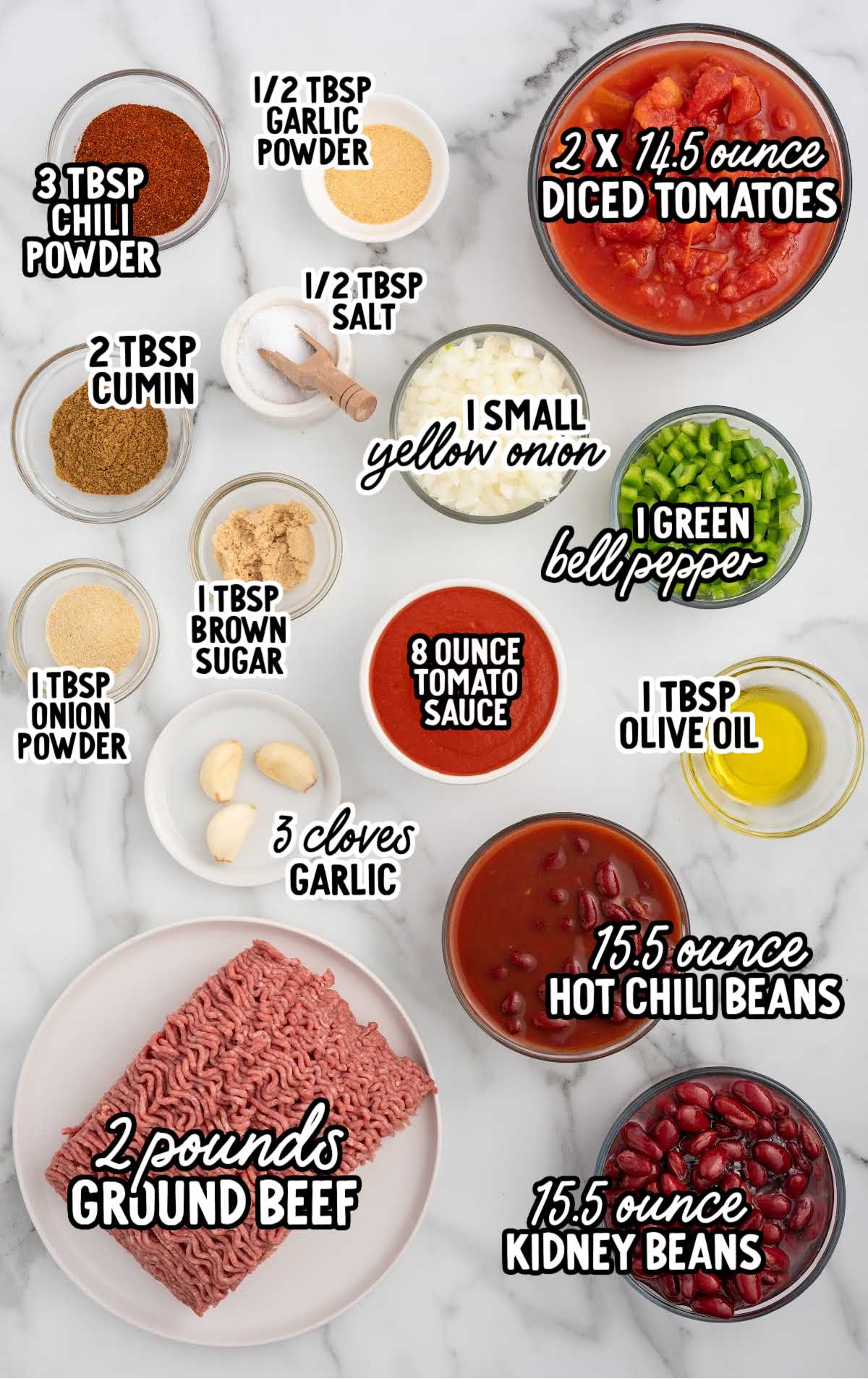 Labeled ingredients for crockpot chili including ground beef, kidney beans, chili beans, tomatoes, spices, onion, and green bell pepper on a white background.