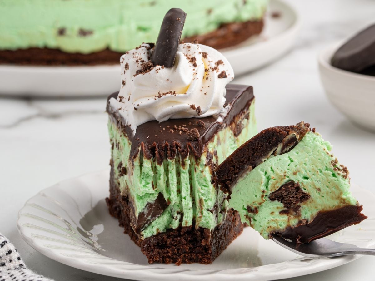 slice of thin mint cheesecake with a forkful taken from it