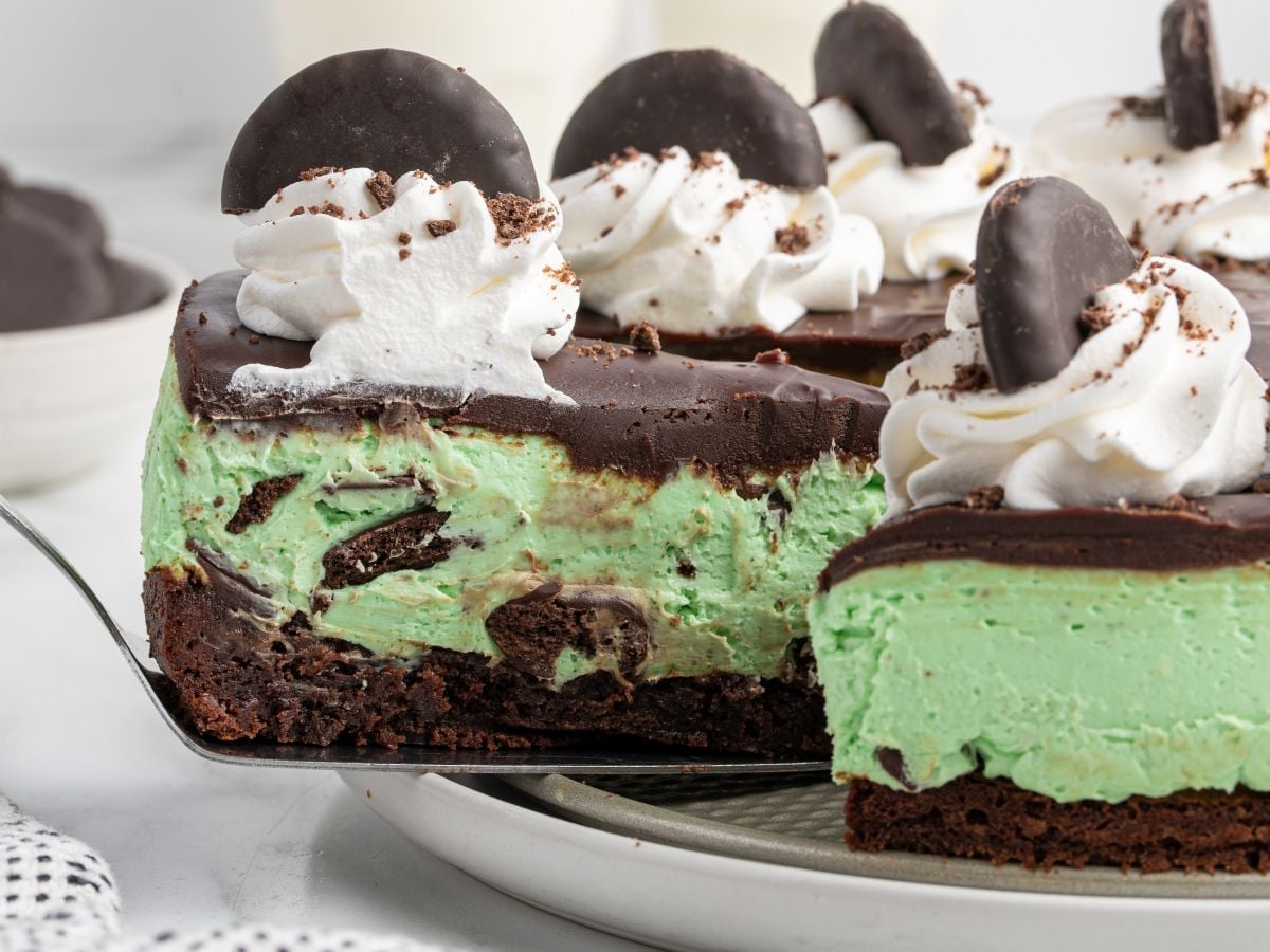 slice being removed from thin mint mint chocolate cheesecake