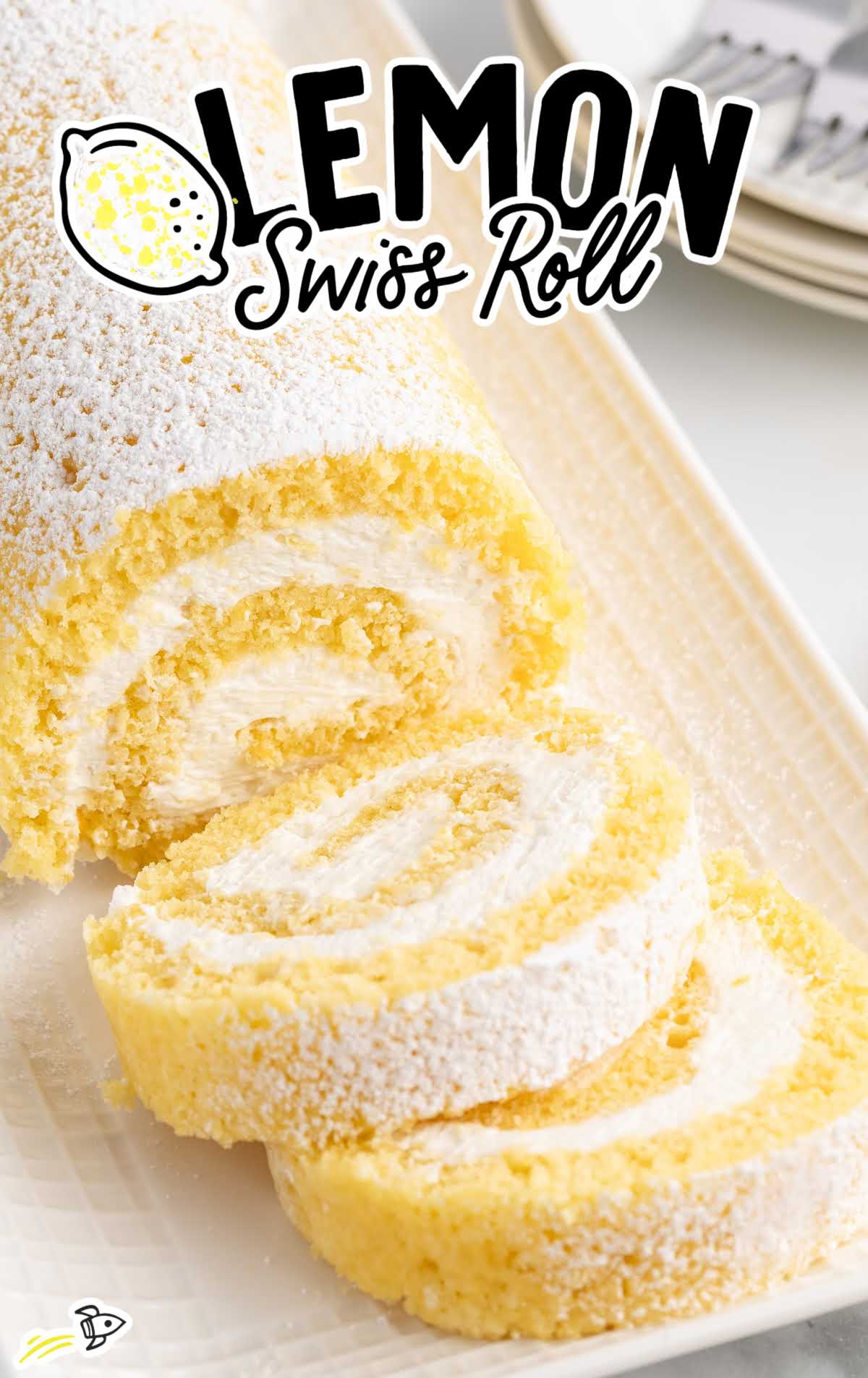 Lemon swiss roll sliced to show spiral of whipped cream filling, topped with powdered sugar