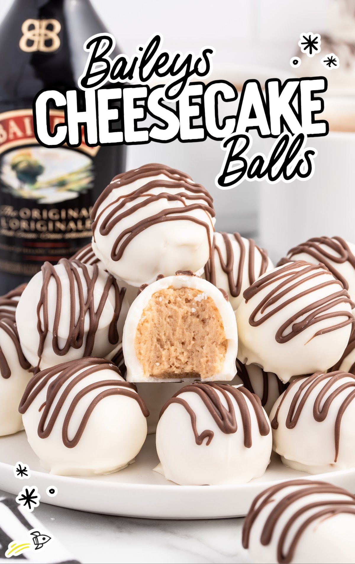 A white plate of Bailey's Cheesecake Balls with a bottle of Baileys