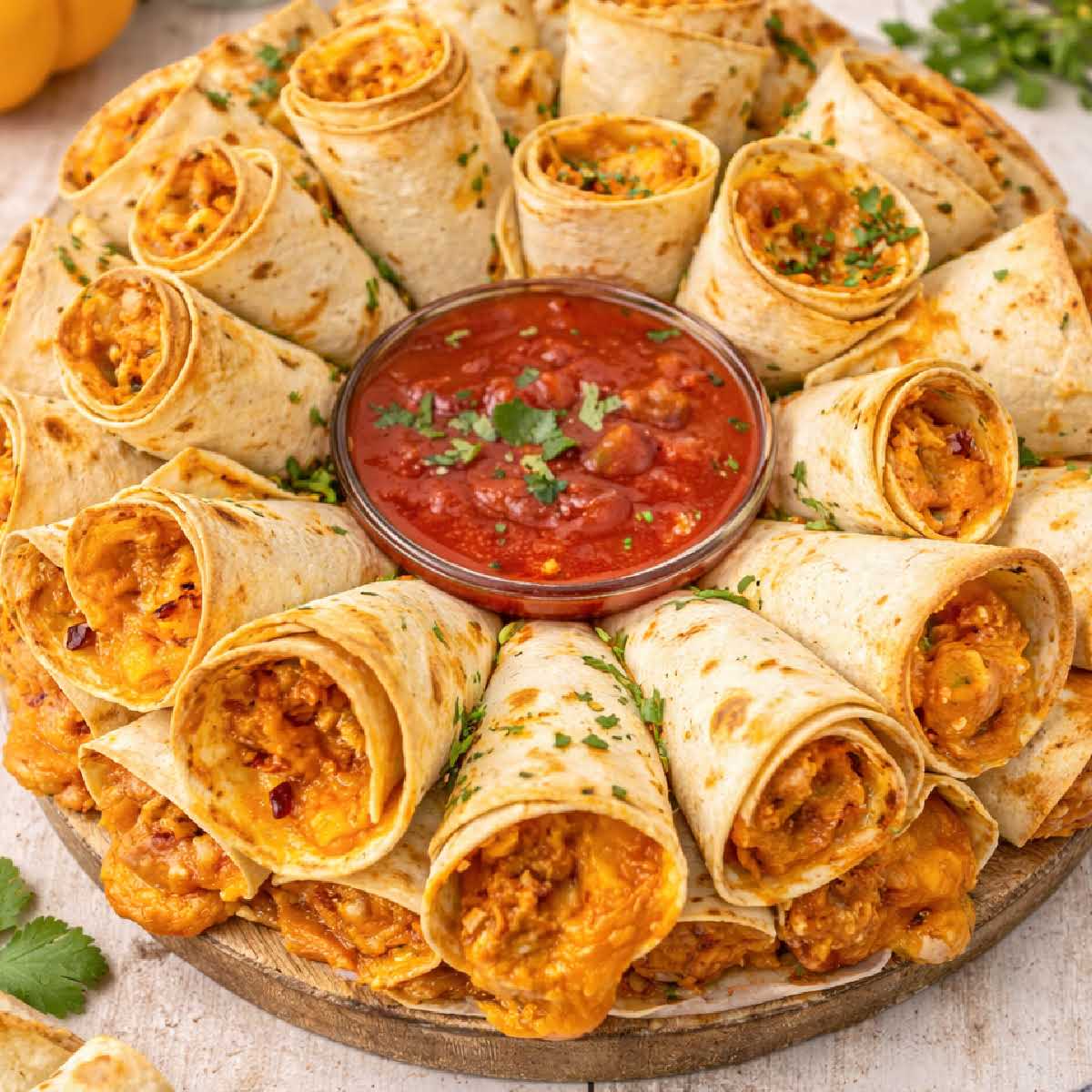 Blooming quesadilla ring arranged in a circle with melted cheese and salsa in the center ready to serve.