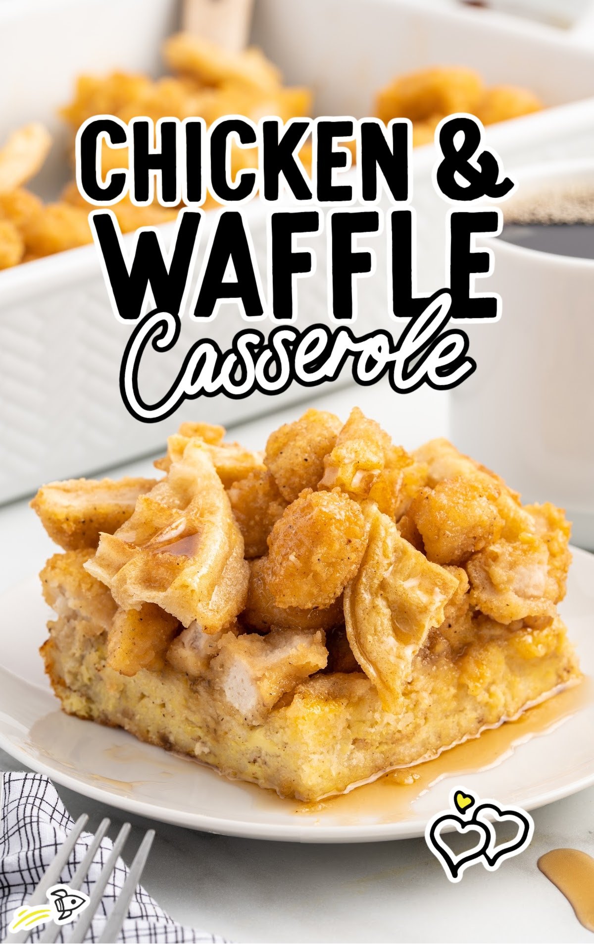 Close-up of a slice of chicken and waffle casserole served on a white plate, topped with syrup, with a cup of coffee and the casserole dish in the background.