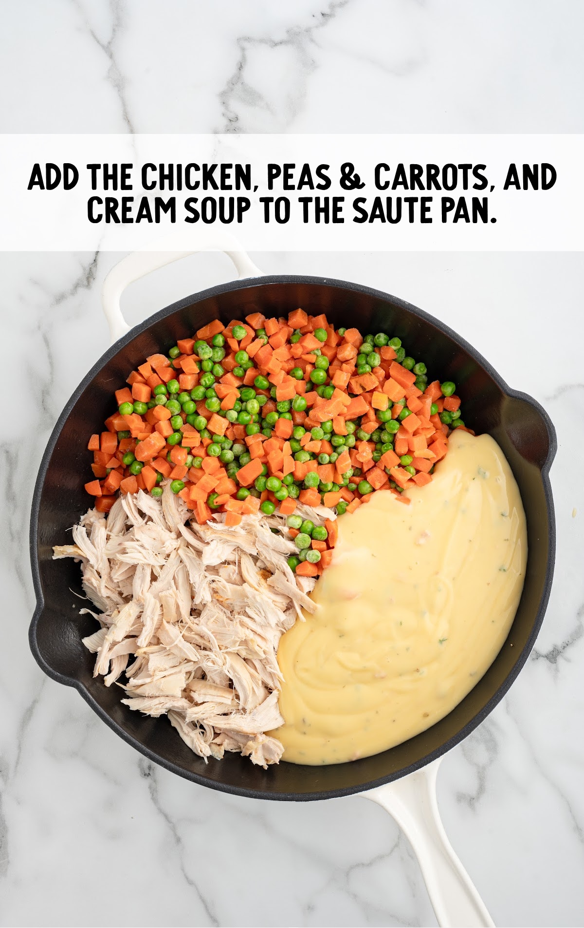 Chicken, peas, carrots, and soup added to a skillet.