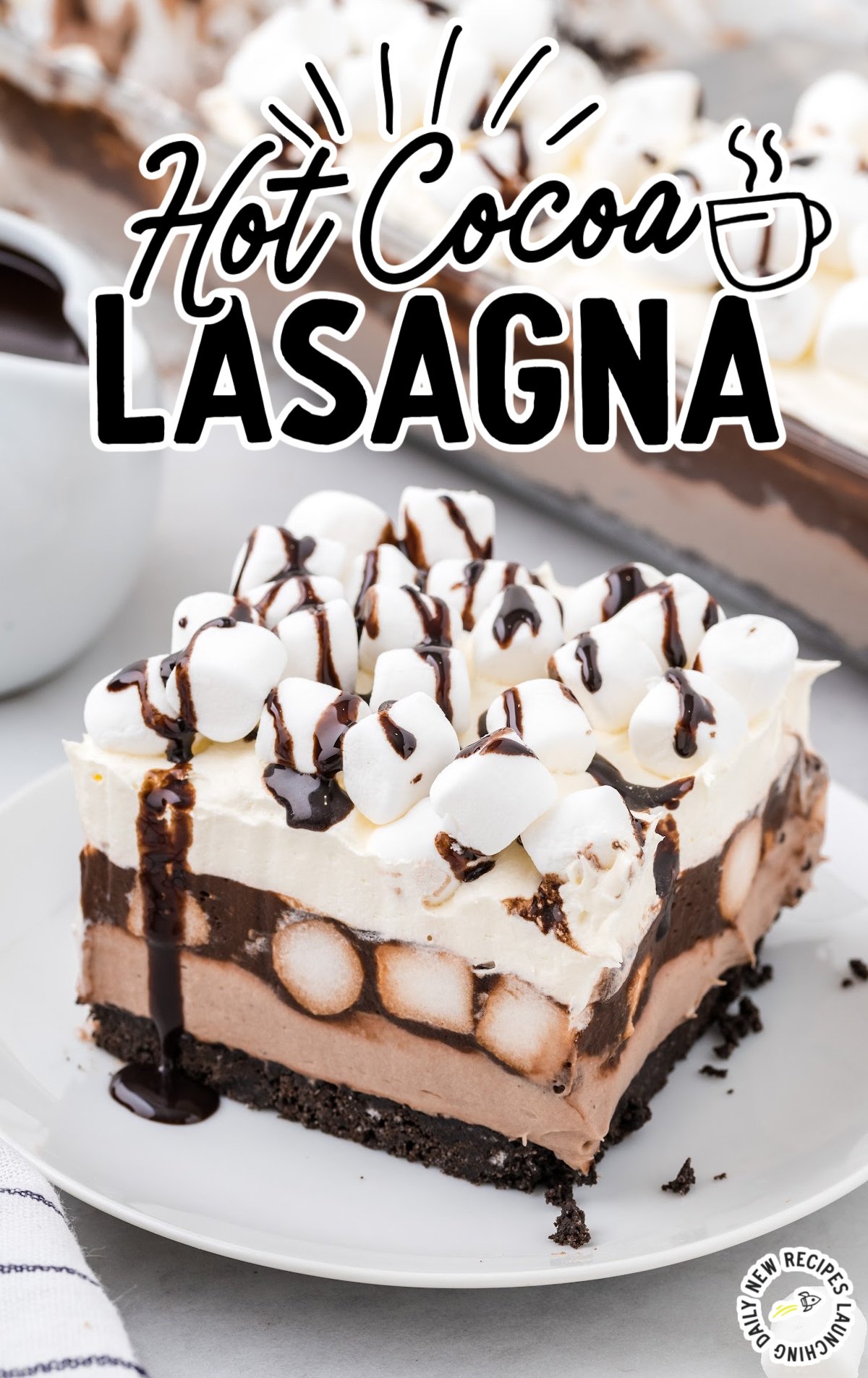 A Hot Cocoa Lasagna is sliced and a piece is on a white plate.