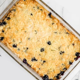 A glass baking dish full of Lemon Blueberry Cobbler.