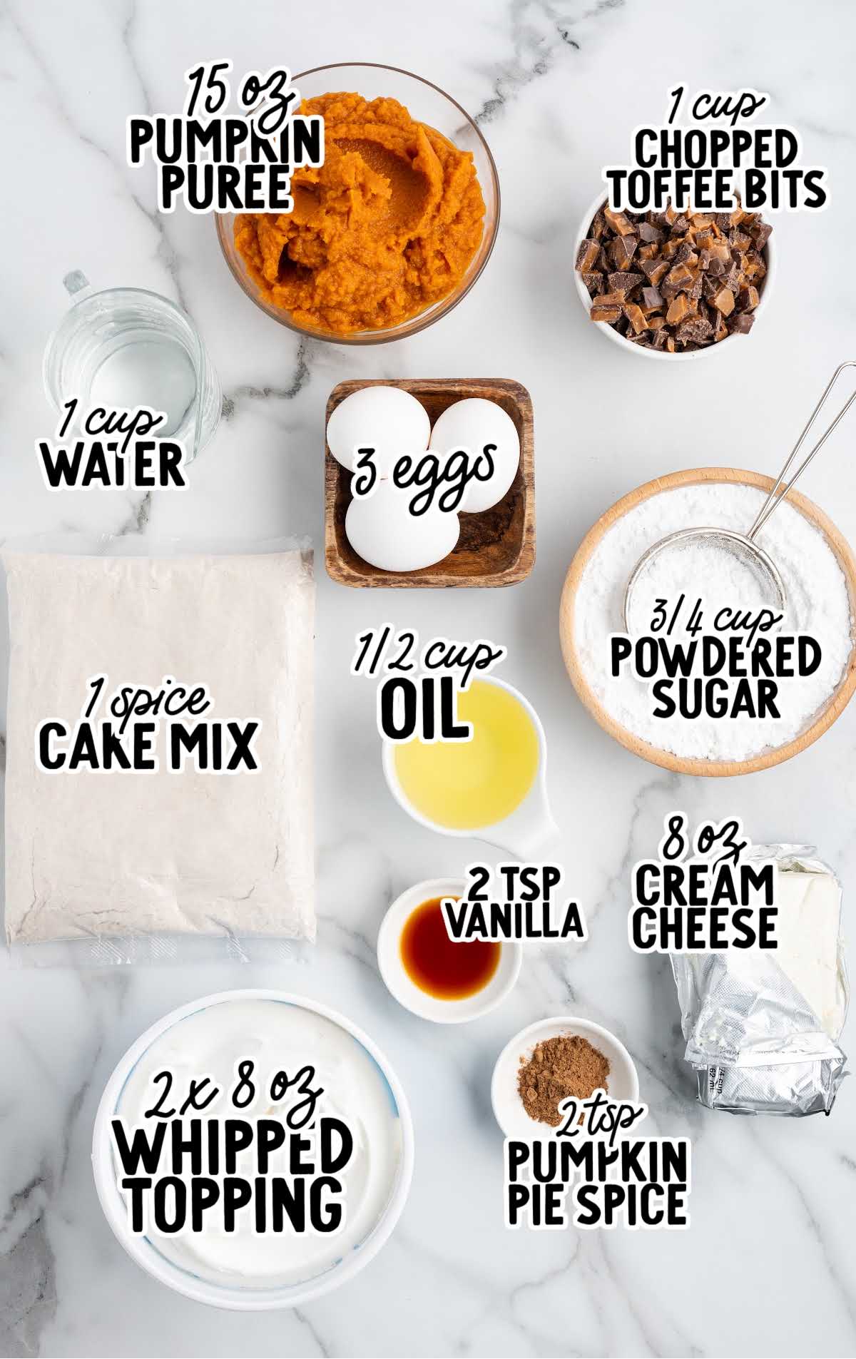 Labeled ingredients for pumpkin trifle including pumpkin puree, whipped topping, spice cake mix, cream cheese, and toffee bits