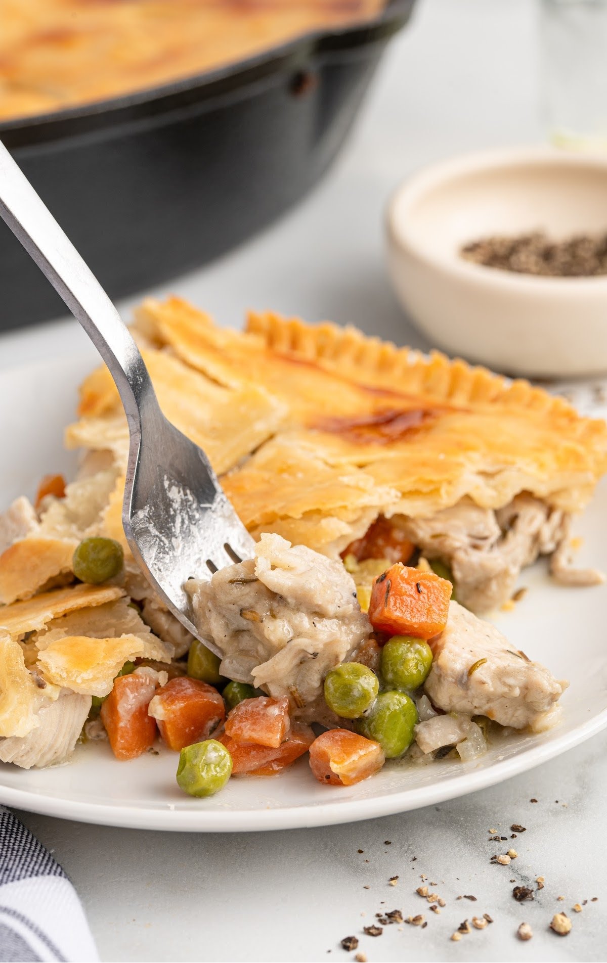 A dinner plate contains a piece of Skillet Chicken Pot Pie.