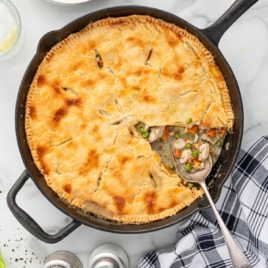 A cast iron skillet full of a baked Skillet Chicken Pot Pie.