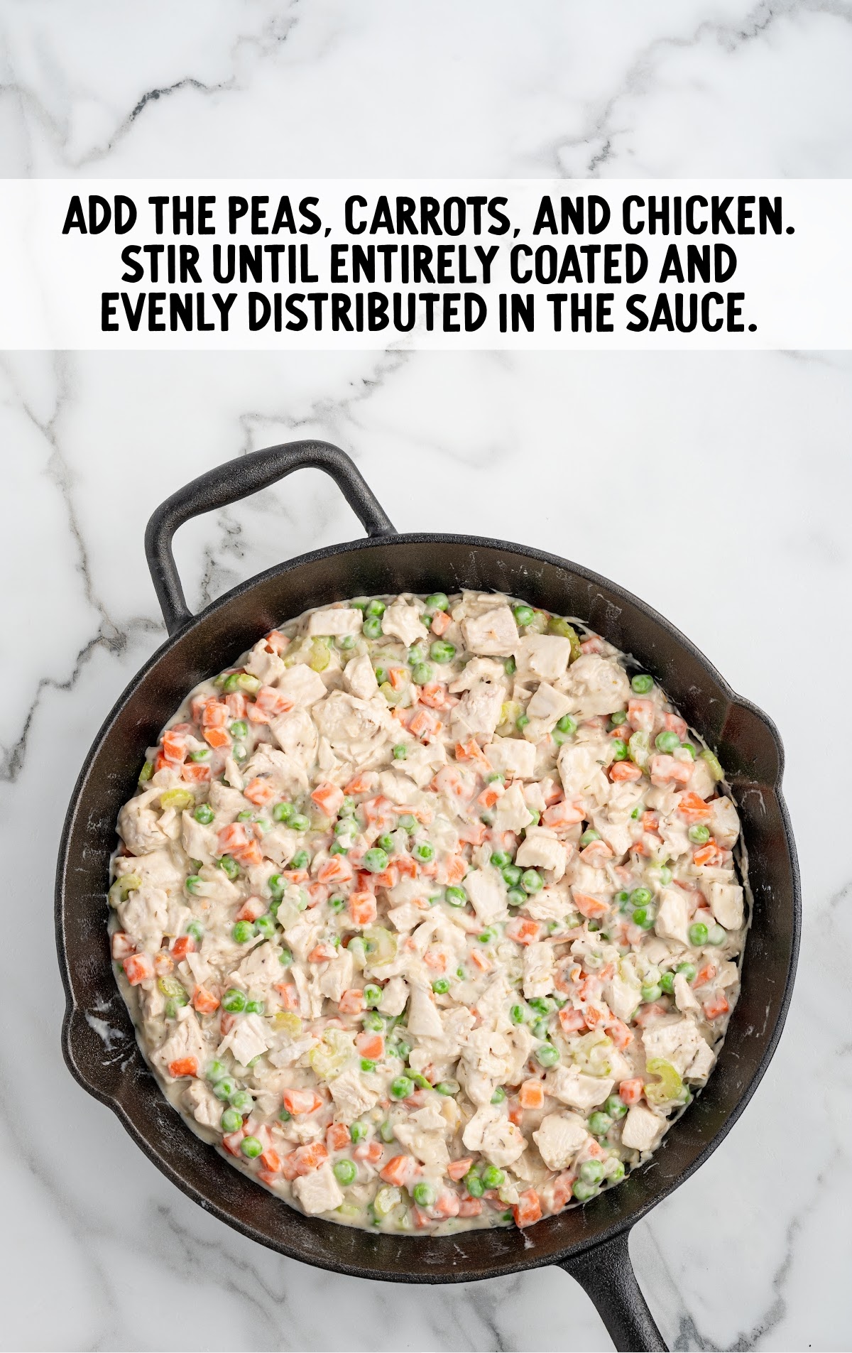 A skillet is full of chicken pot pie filling.