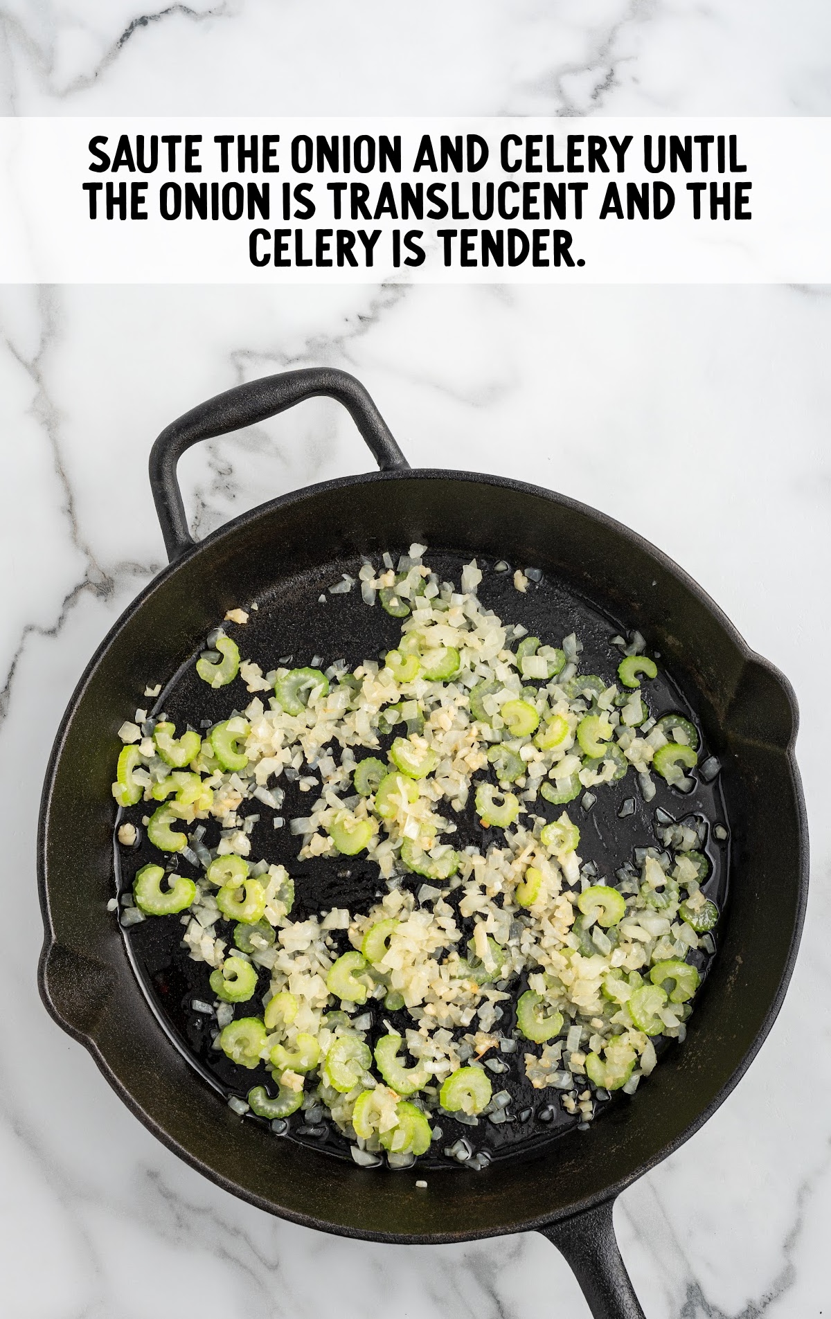 A skillet is full of sauteed celery and onions.