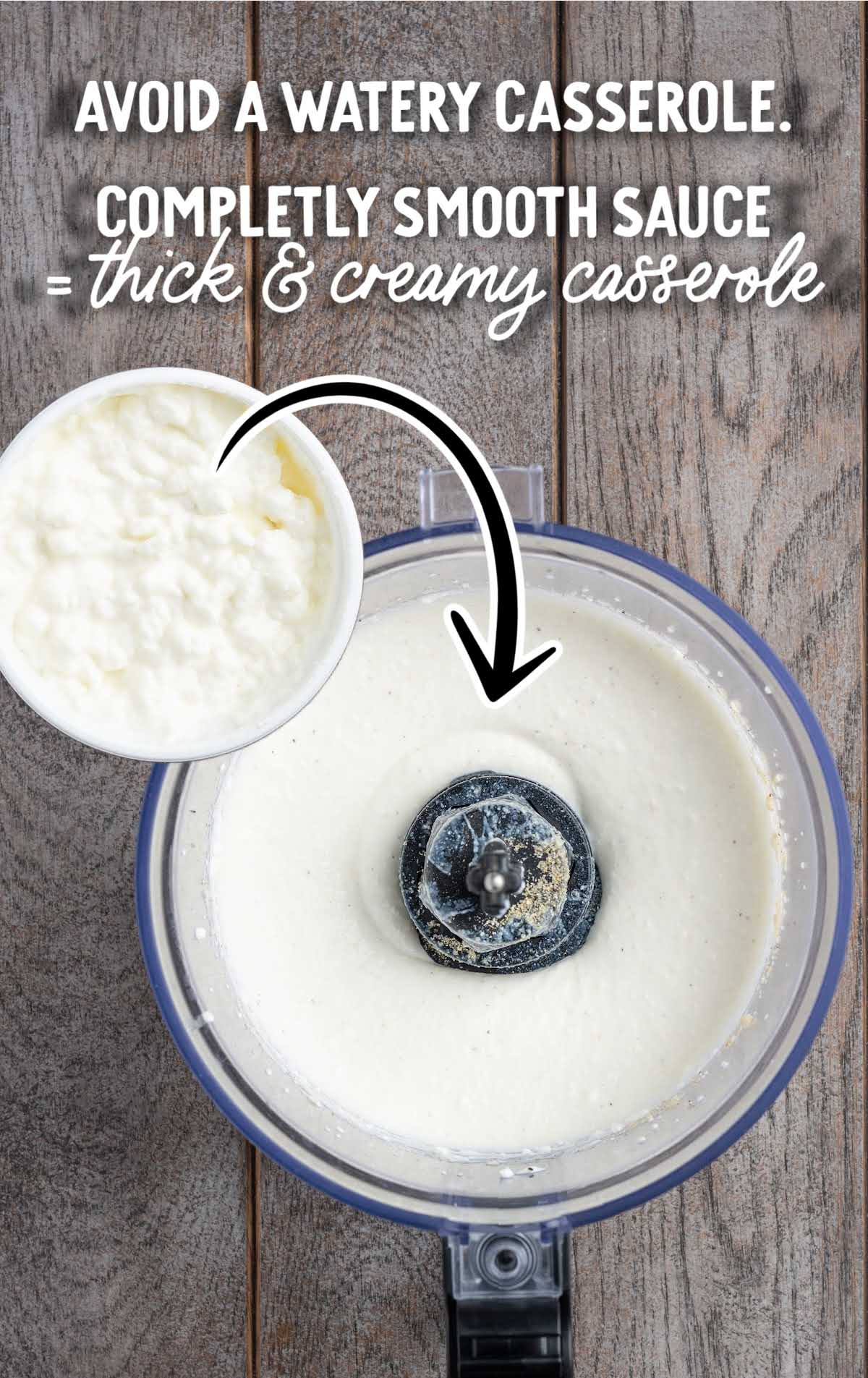 Blended cottage cheese sauce in a food processor for spinach and artichoke chicken casserole.