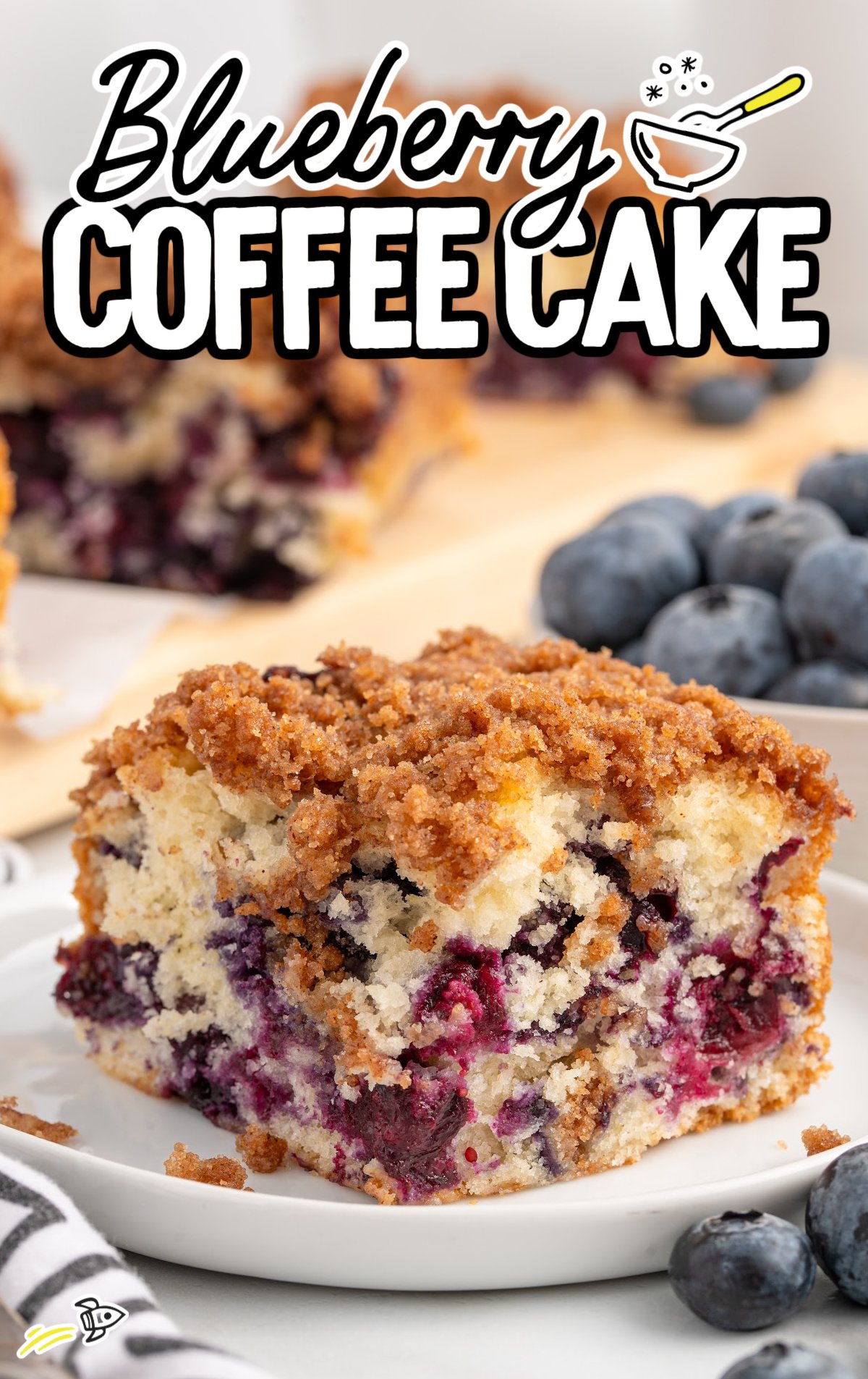 A slice of Blueberry Coffee Cake on a white palte.