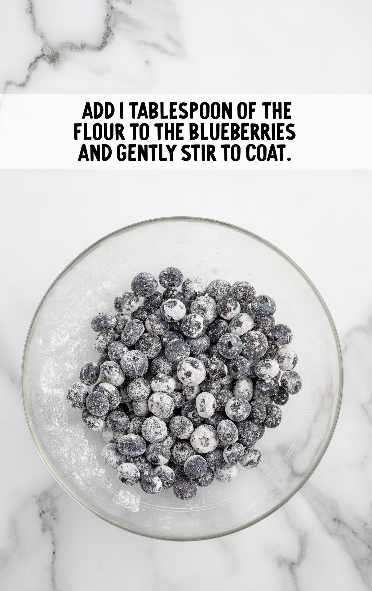 The blueberries are mixed together with flour.