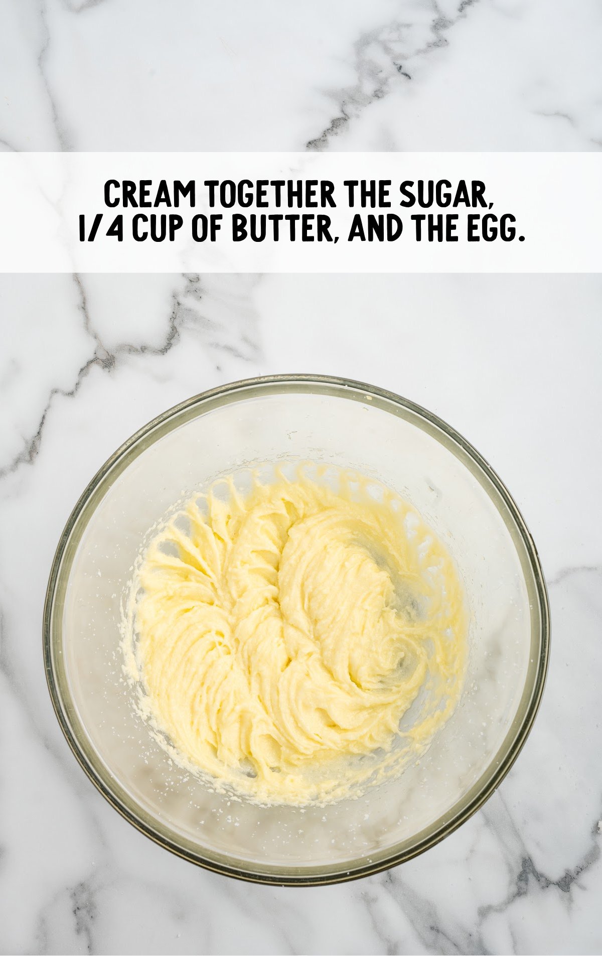 The sugar, butter, and egg are mixed together.