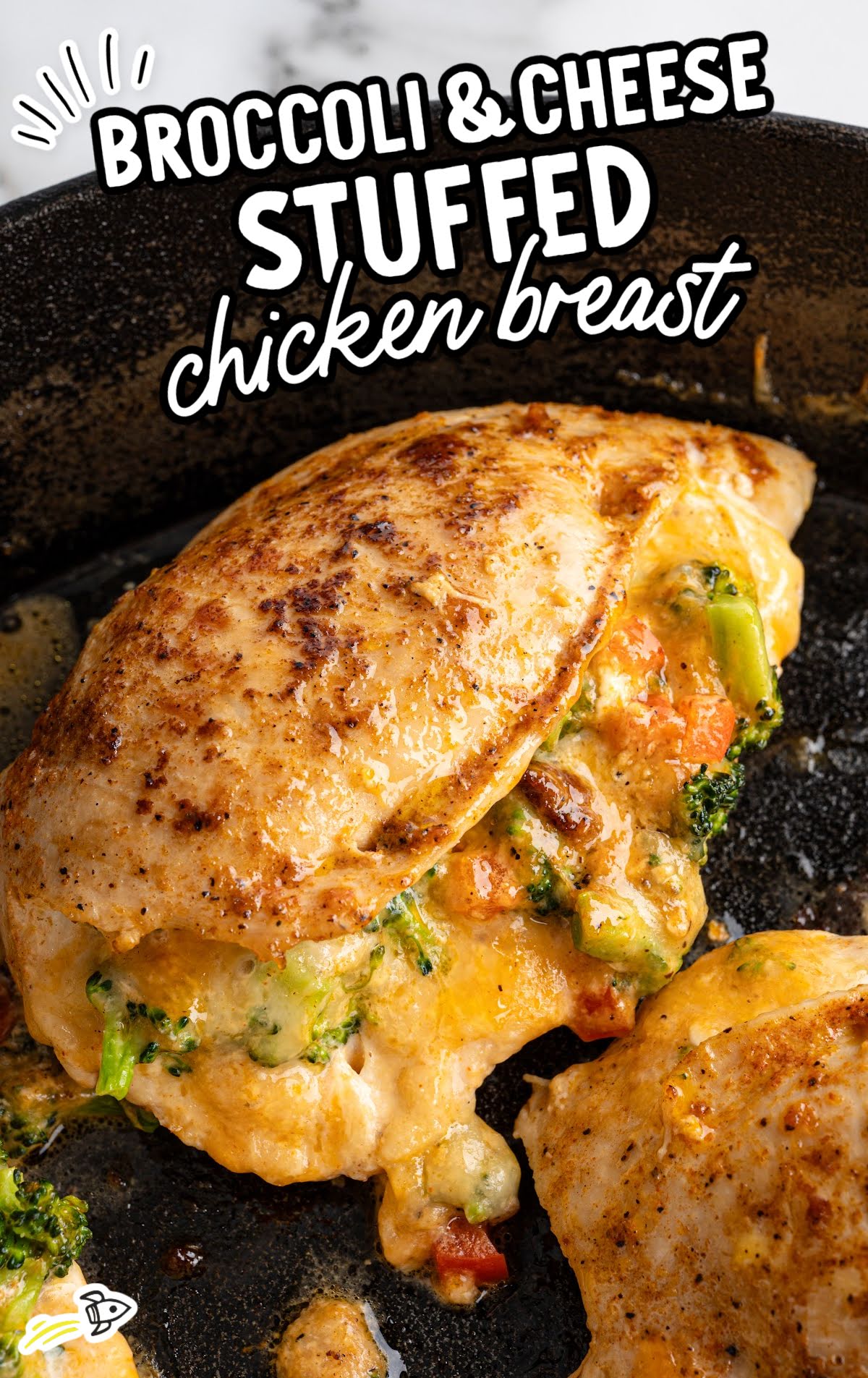 Golden brown stuffed chicken breast filled with broccoli, carrots, and melted cheese.