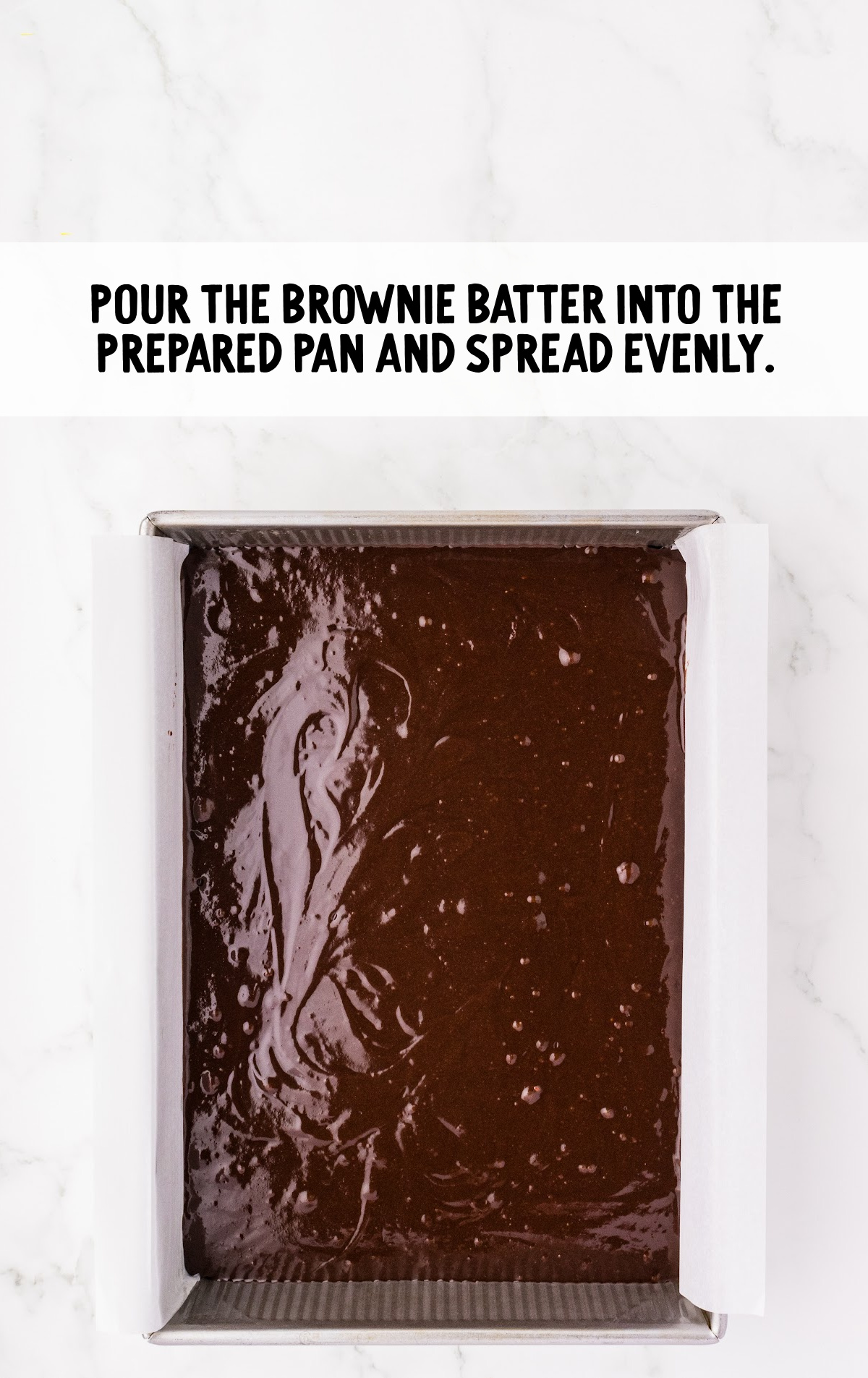 The brownie batter is in a baking pan.