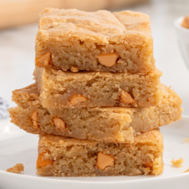 a close up shot Butterscotch Brownies stacked on top of each other on a plate