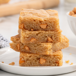 a close up shot Butterscotch Brownies stacked on top of each other on a plate