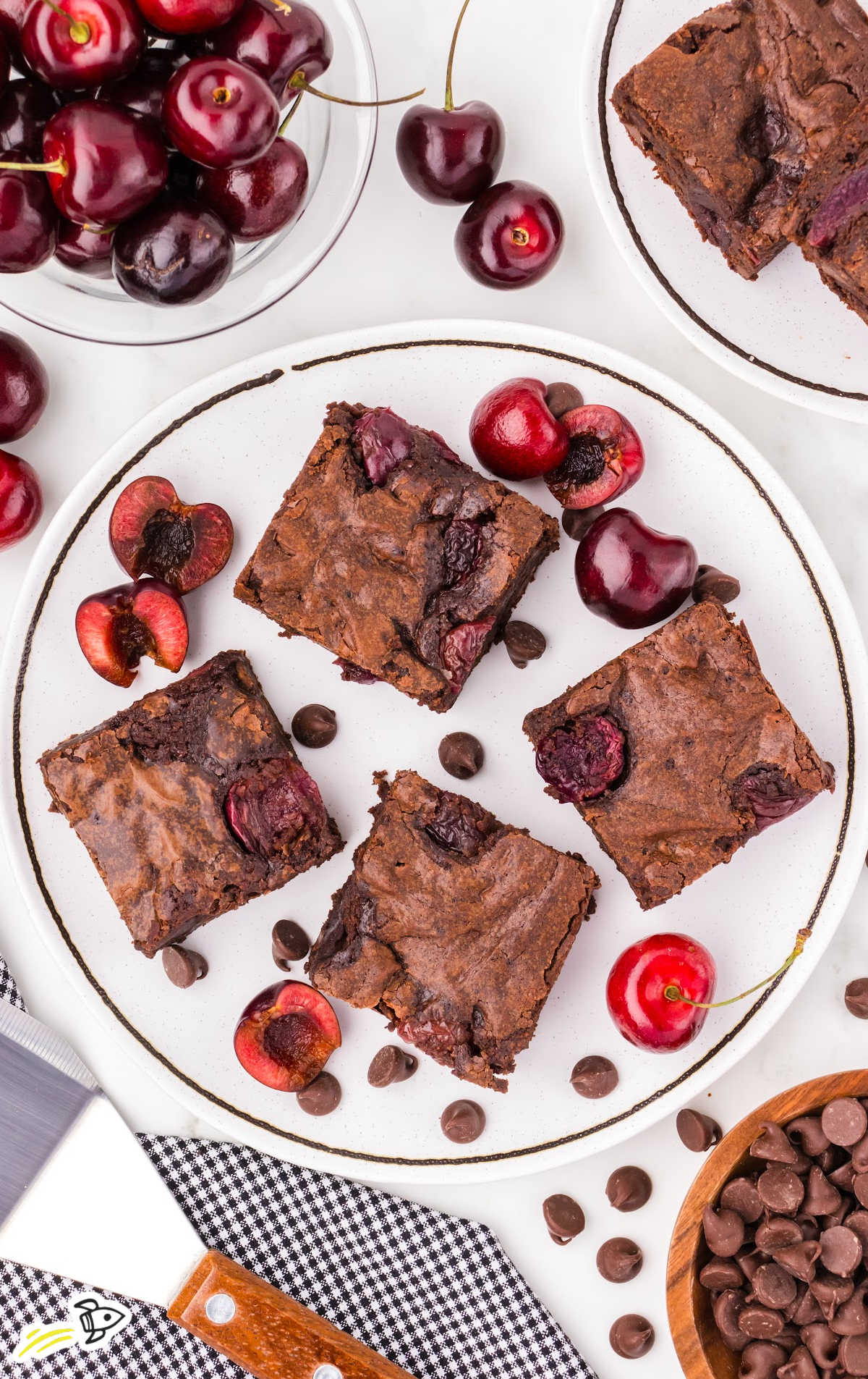 slices of cherry brownies stacked on a plate