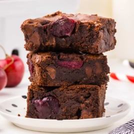 slices of cherry brownies stacked on top of each other on a plate