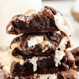 A stack of gooey Chocolate Marshmallow Cookies split open. The inside looks moist and tender.