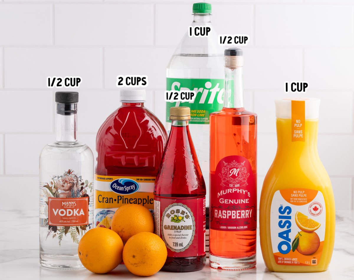 Ingredients for Christmas morning punch including vodka, cranberry pineapple juice, orange juice, Sprite, raspberry liqueur, grenadine, and fresh oranges