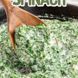 a skillet of creamed spinach with a wooden spoon