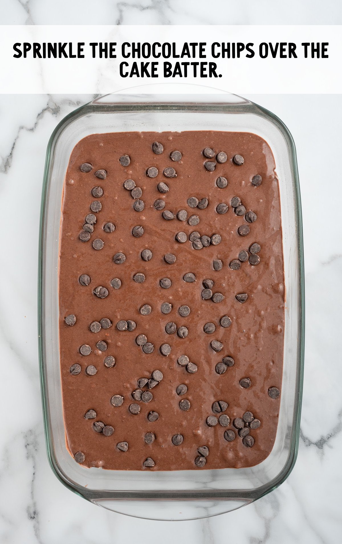 chocolate chips sprinkled on top of the cake batter in a baking dish