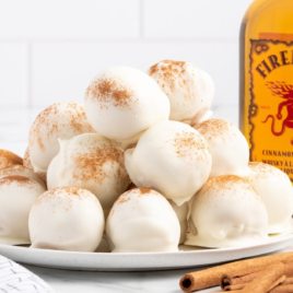 A plateful of Fireball Truffles beside a bottle of fireball whisky.