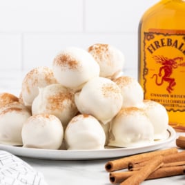 A plate of Fireball Truffles and a bottle of fireball whiskey.