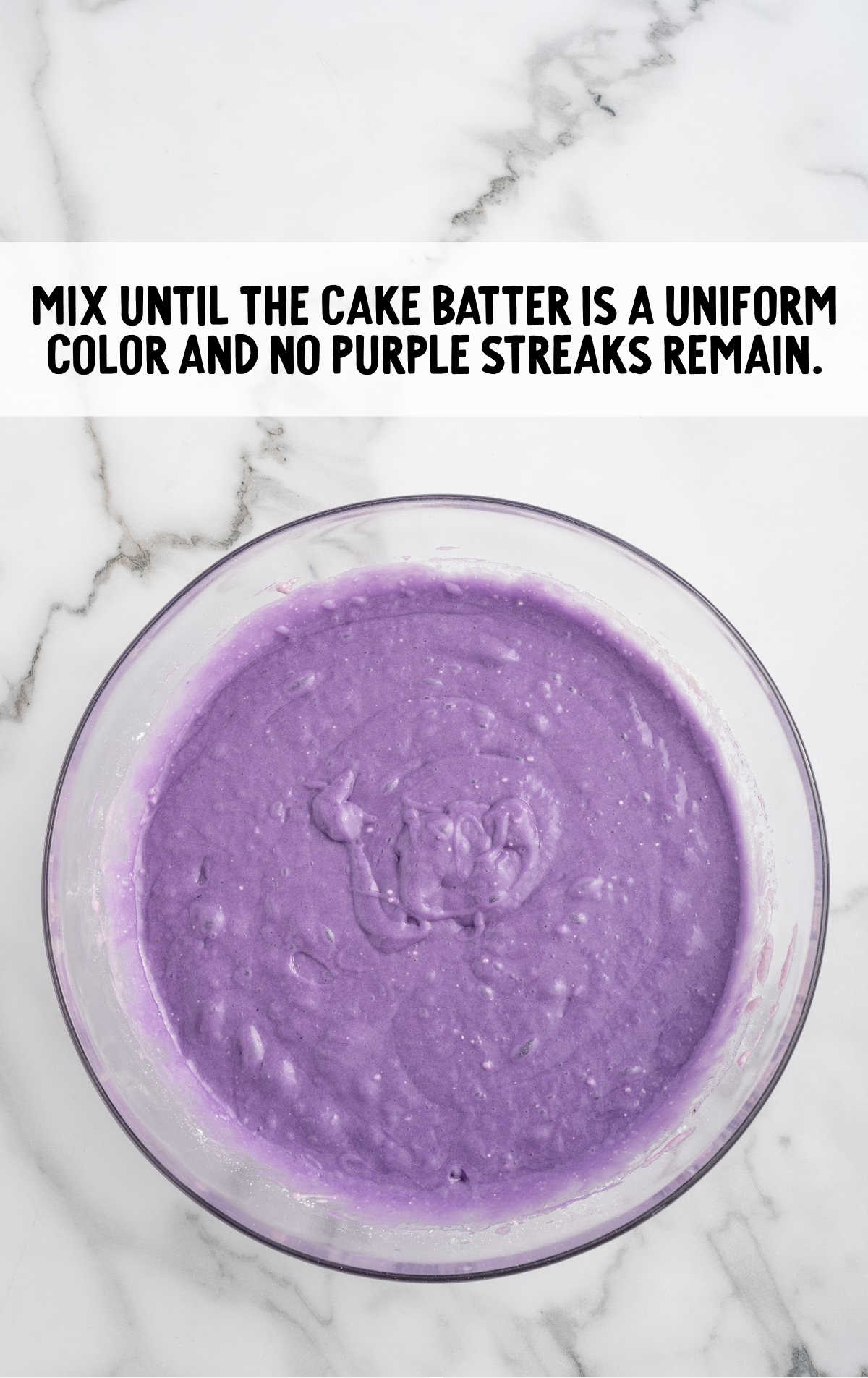 food coloring added to the cupcake batter in a bowl