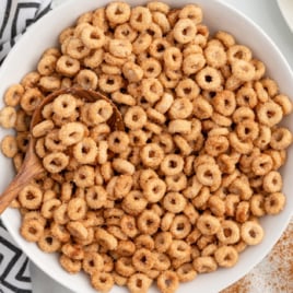 A white bowl full of hot buttered cheerios.