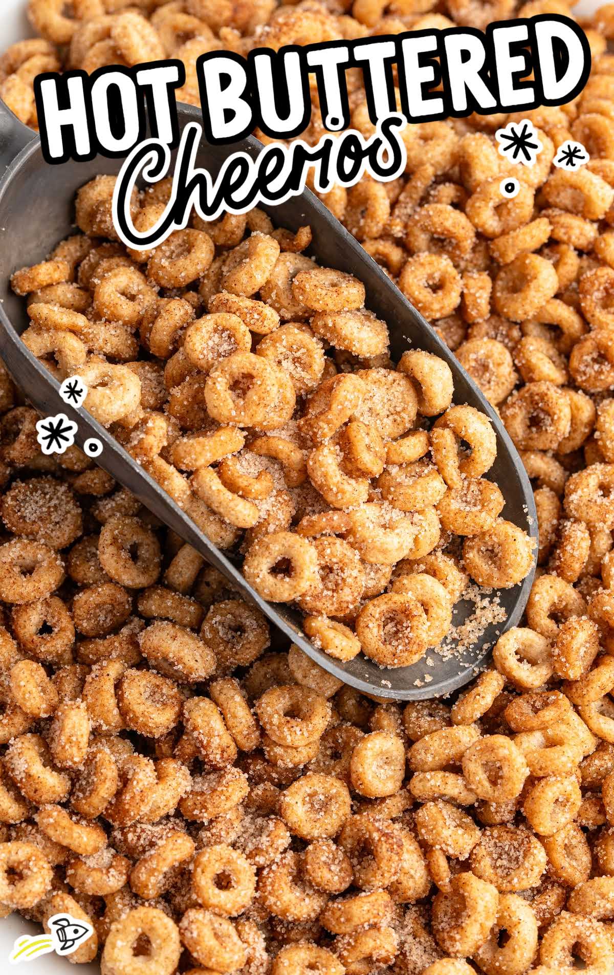 Hot buttered Cheerios scooped into a metal scoop with text overlay