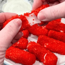 a plate of Hot Cheeto Cheese Sticks with a bowl of ranch