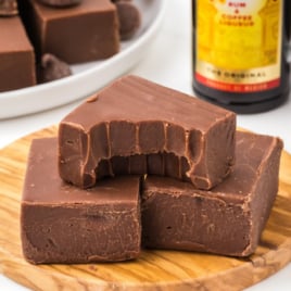 A few pieces of Kahlua Fudge on a wooden serving board.