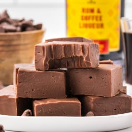 A stack of fudge on a white plate.