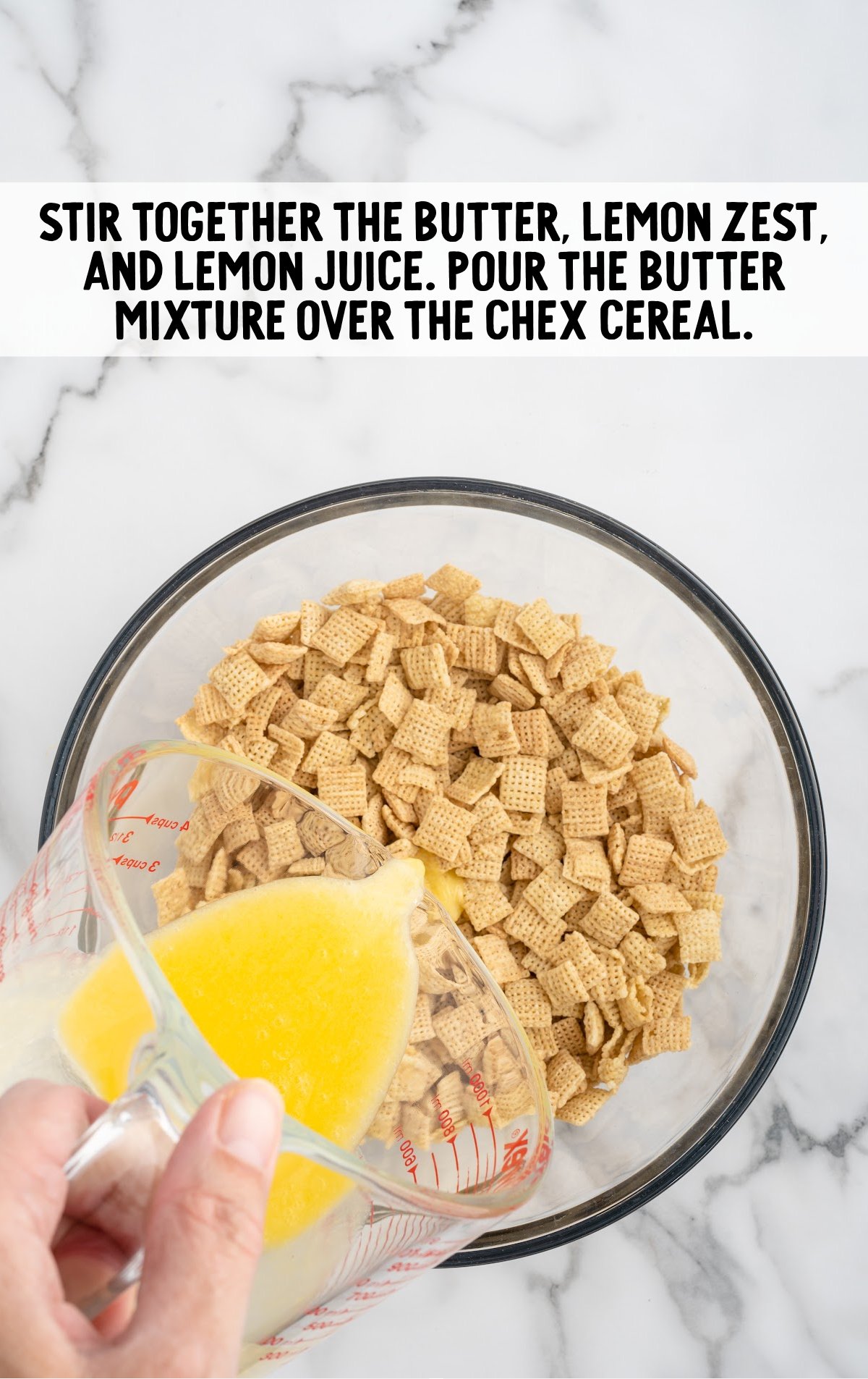 the butter mixture is poured over the chex mix