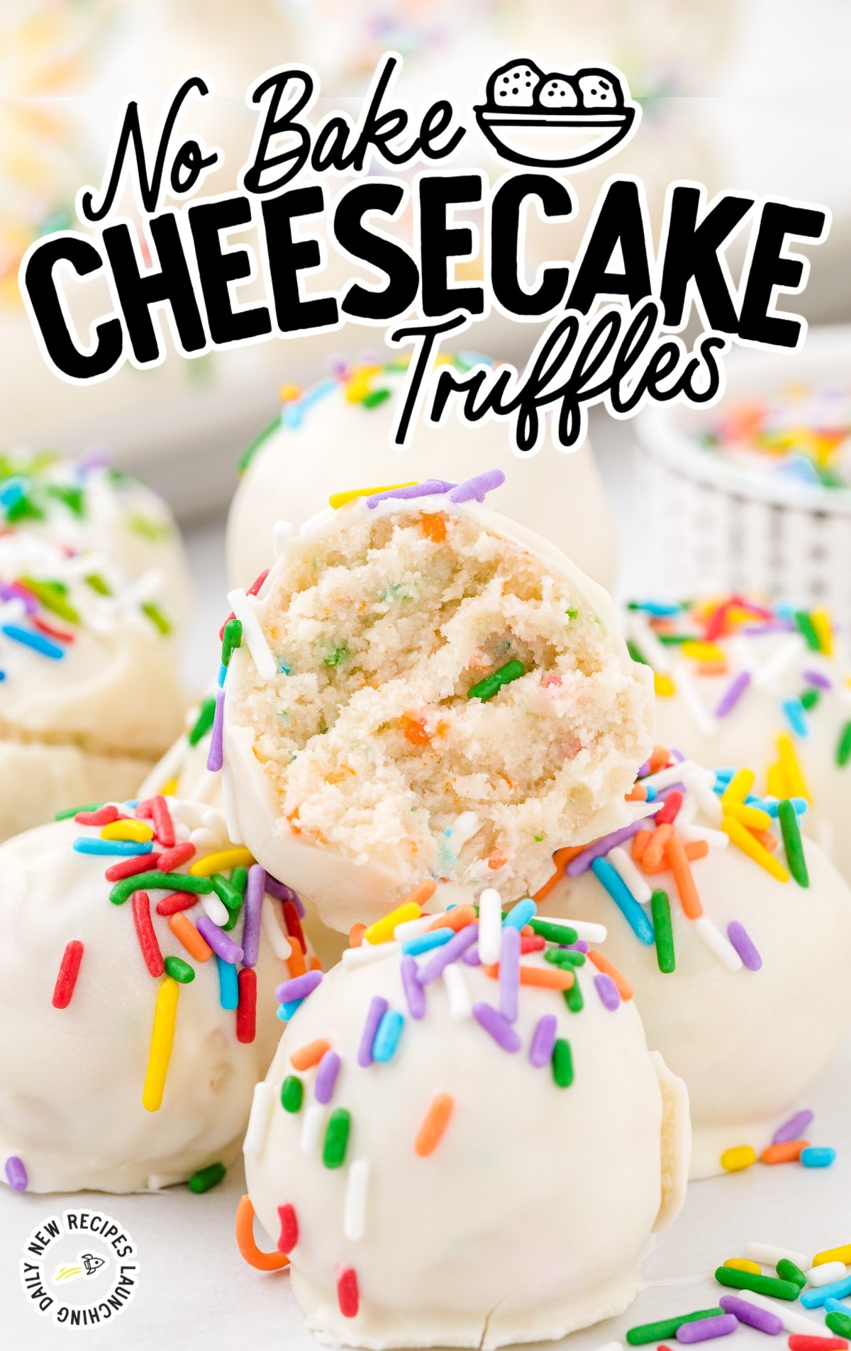 A plate of no bake cheesecake truffles with rainbow sprinkles. One has a bite out of it. 