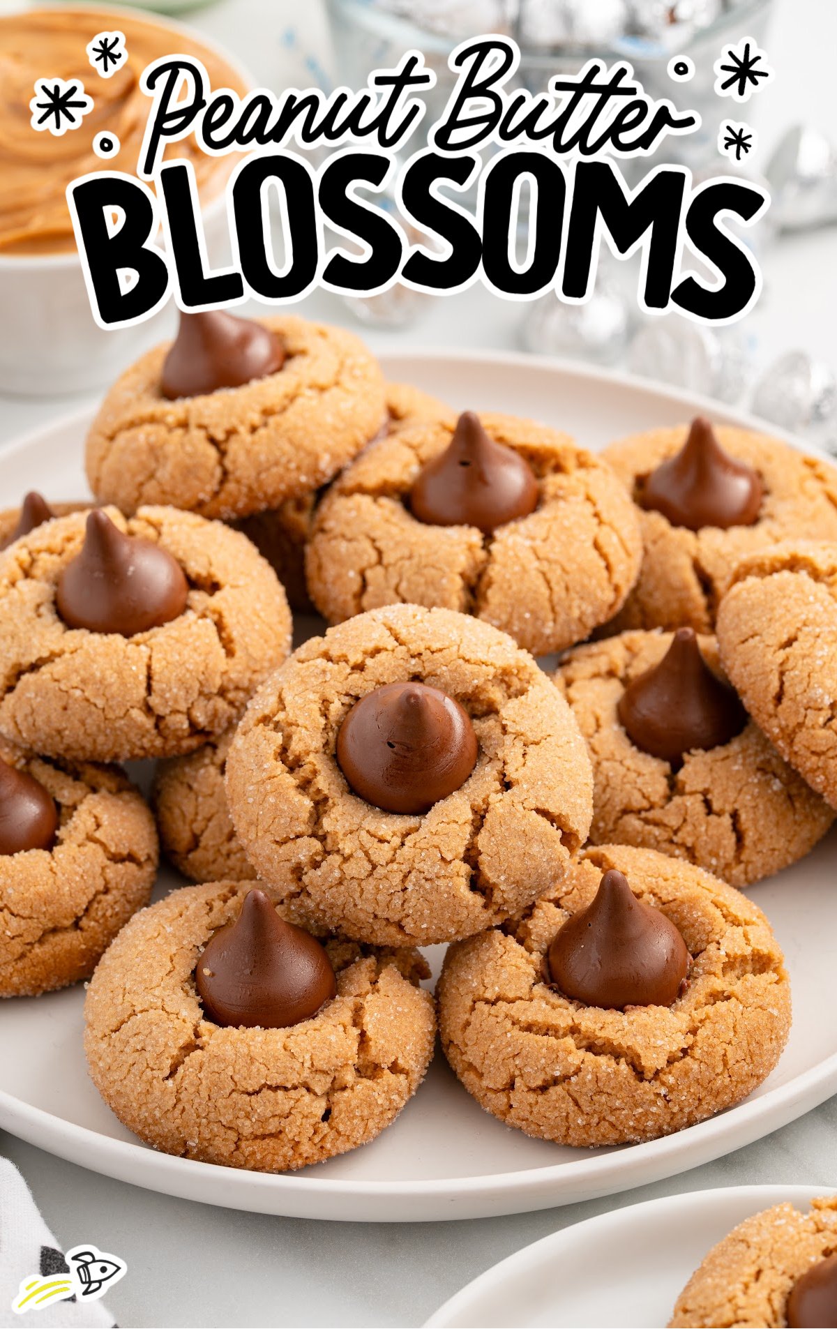 A white plate full of peanut butter blossoms.