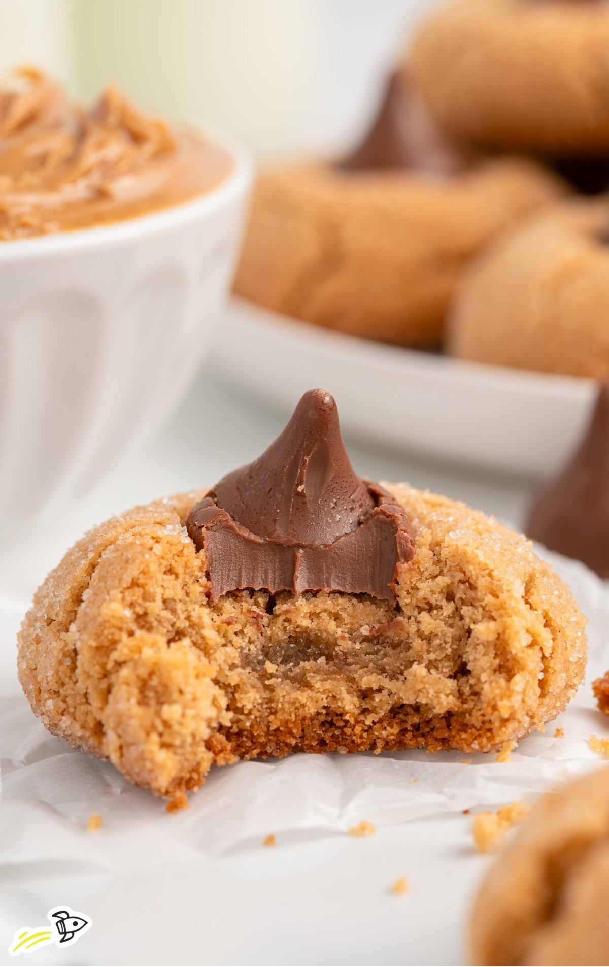 A Peanut Butter Blossom with a big bite out of it.