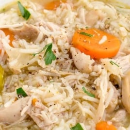 Chicken and rice soup Pinterest image featuring ladle of soup with carrots, rice, and shredded chicken