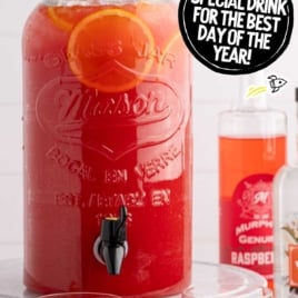 Christmas morning grown-up punch in glasses with orange slices, served from a large dispenser