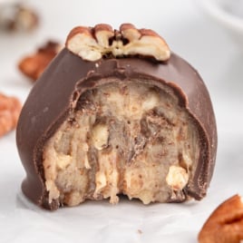 a Condensed Milk Pecan Ball with a bite taken out of it