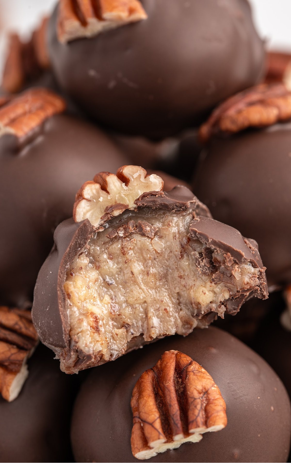 a bowl of Condensed Milk Pecan Balls with a bite taken out of one of them