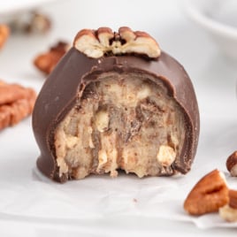 a Condensed Milk Pecan Ball with a bite taken out of it