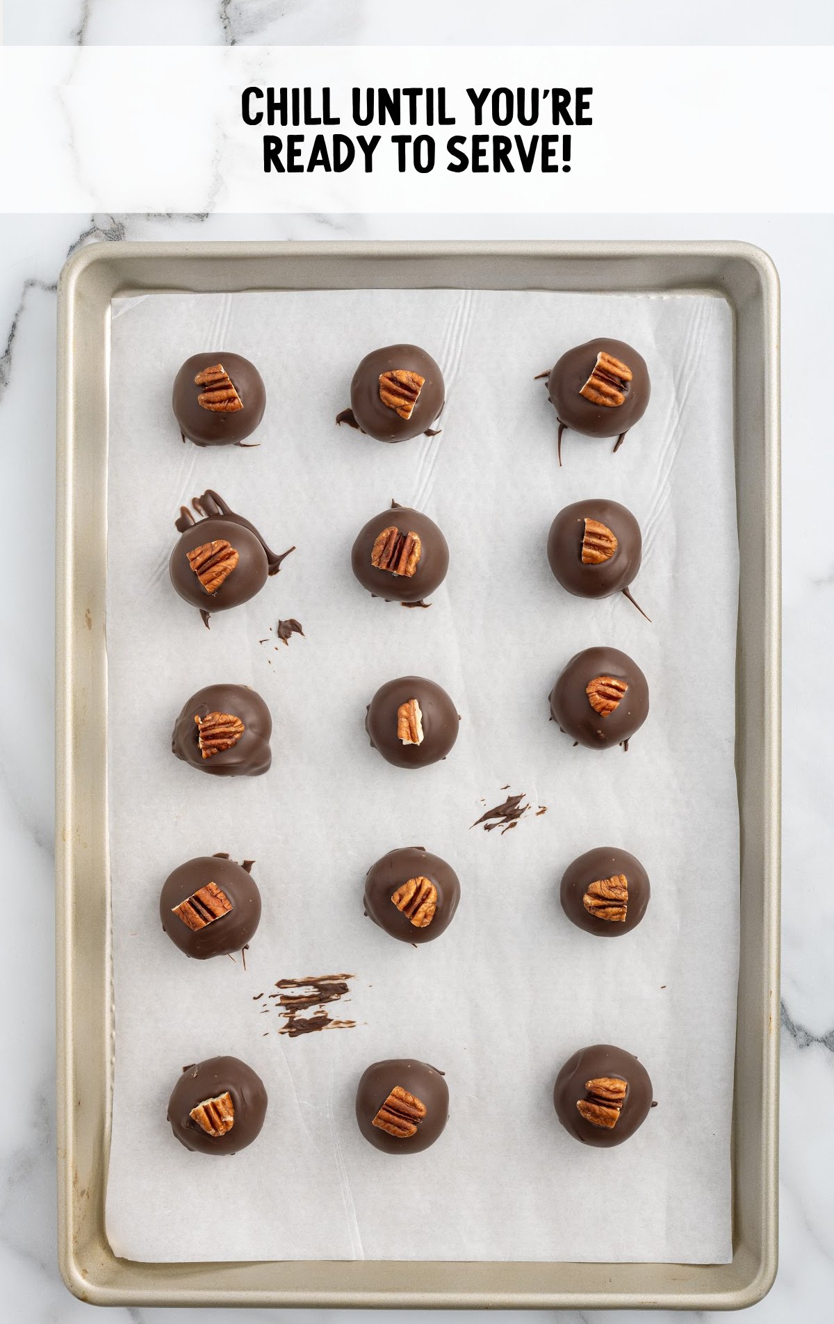 pecan balls on a parchment lined baking sheet