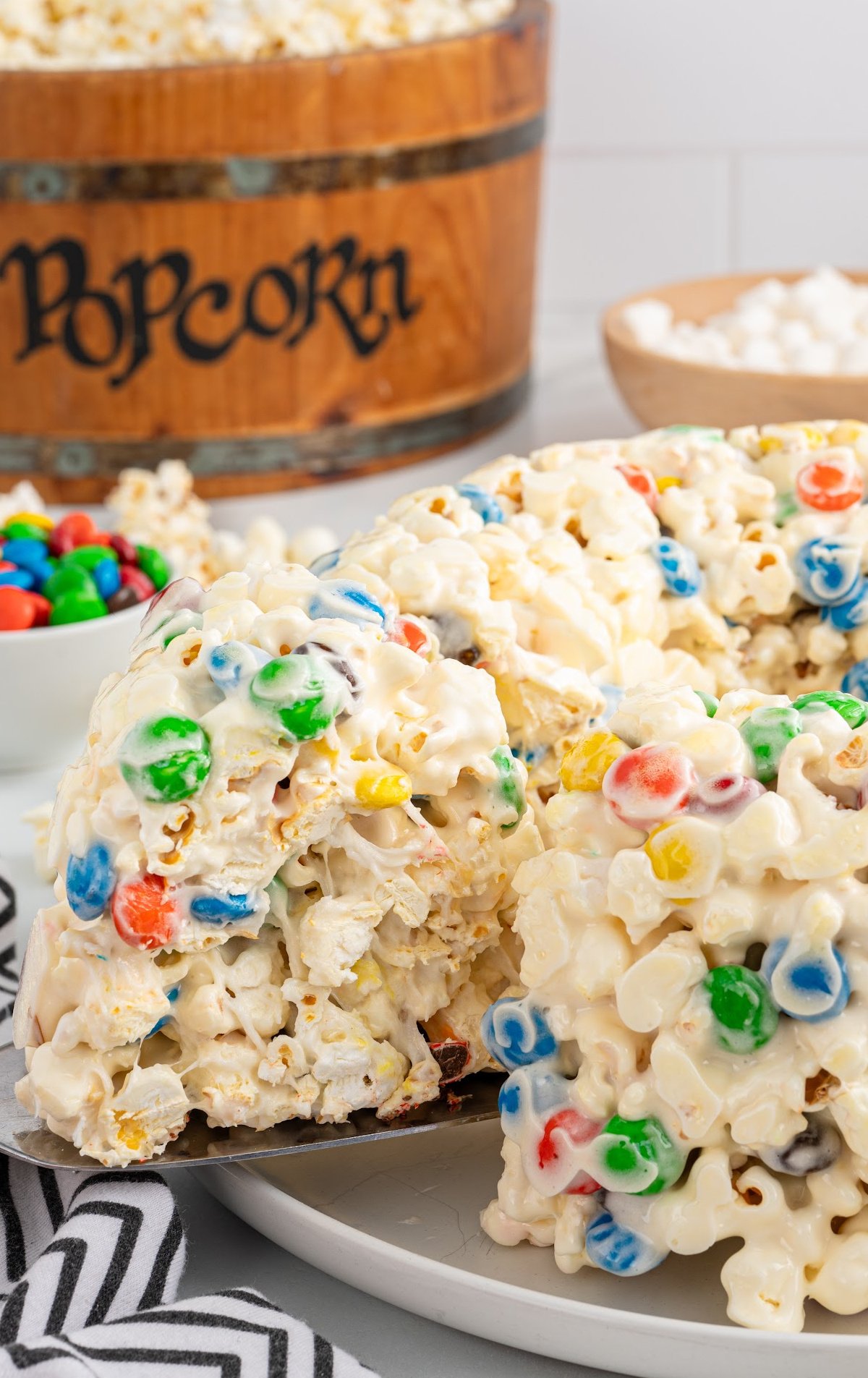 a plate of Popcorn Cake with a slice being taken out of it