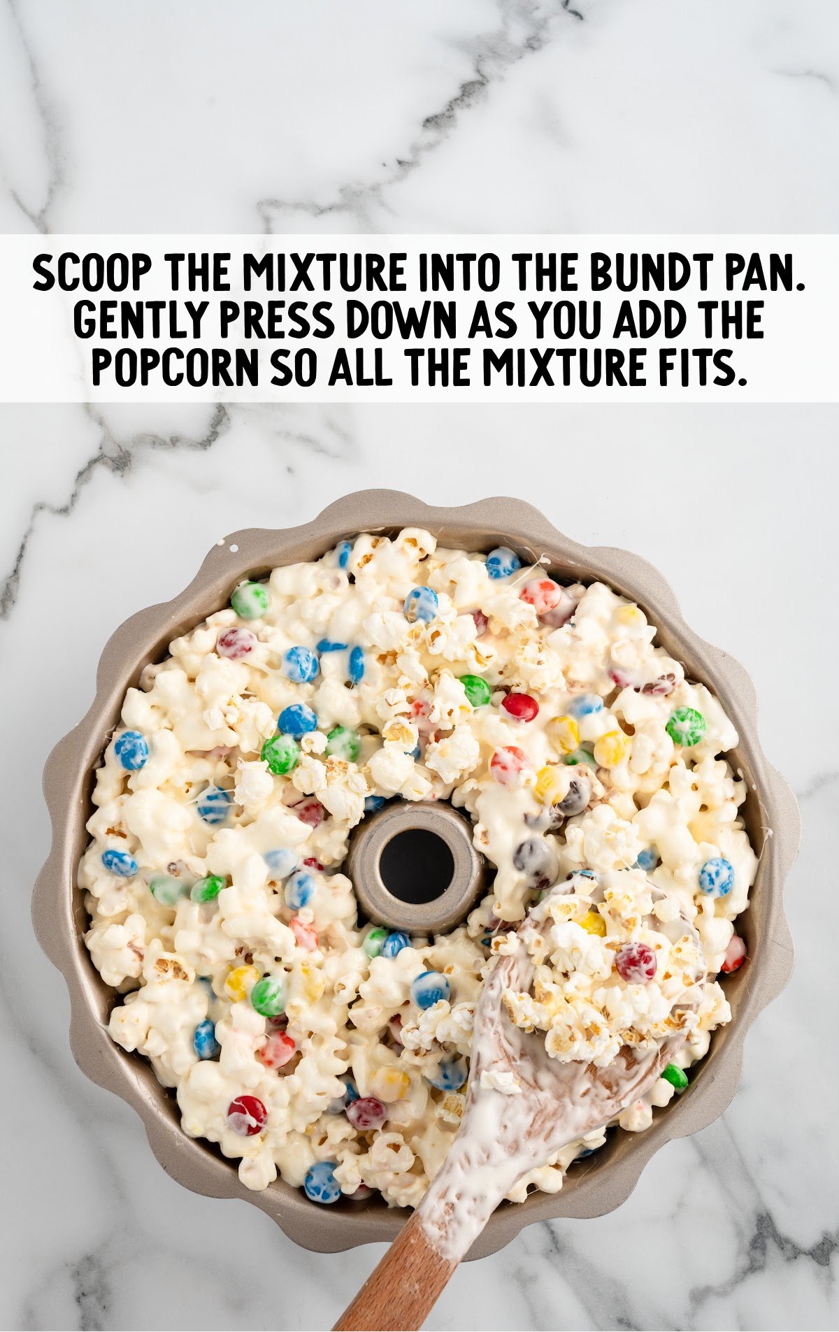 popcorn cake mixture spooned into a bundt pan