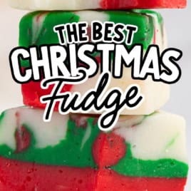 Four stacked pieces of red, green, and white Christmas Fudge with text overlay reading The Best Christmas Fudge Recipe and Vintage Recipe!! in bold, festive fonts.